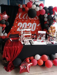 the table is set up with balloons and decorations