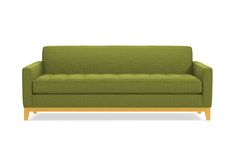 a green couch sitting on top of a white floor