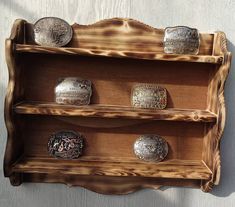 a wooden shelf with many different metal objects on it