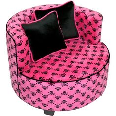 a pink chair with black pillows on it