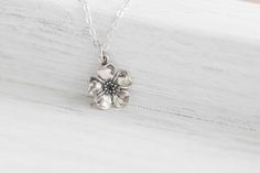 "Sterling Silver Cherry Blossom Charm Necklace. A delicate and beautifully detailed charm. Cherry blossoms are a symbolic flower of spring, a time of renewal, and the fleeting nature of life. In Japanese culture the cherry blossom represents the fragility and the beauty of life. Make your necklace extra special by personalizing it with one of our sterling silver birthstone charms. ✥ Sterling Silver Cherry Blossom Charm (15mm including jump ring) ✥ Sterling Silver Cable Chain (16-20\") ✥ Comes be Flower Pendant Jewelry For Spring Wedding, Spring Wedding Jewelry: Flower Pendant, Spring Wedding Jewelry With Flower Pendant, Blossom Flower Necklaces For Wedding, Silver Necklace With Flower Charm For Spring, Silver Necklaces With Flower Charm For Spring, Delicate Flower Necklace For Spring, Delicate Flower Necklaces For Spring, Blossom Color Jewelry With Flower Charm