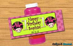 a pink bottle with a ladybug design on it and the words happy birthday sopha