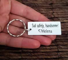 someone is holding a keychain that says, sail safely, handsome helena