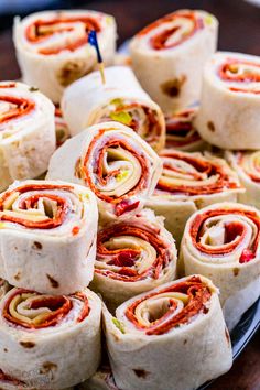 a plate full of rolled up food items