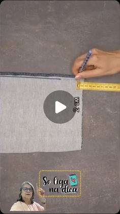 someone is measuring the length of a piece of fabric with a ruler on top of it