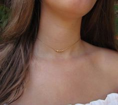 Delicate choker necklace with dainty beads in 14k gold fill or sterling silver. These beads are inspired by the Black Pepper seeds! Personalize your necklace with the number of beads you would like (choose in the drop-down menu). This gold beaded necklace is a great everyday stacking necklace or wear it on it's own for a minimalist look. #necklace #layerednecklace #RavitSchwartz Simple Gold Choker Necklace, Delicate Choker Necklace, Gold Beaded Necklace, Delicate Choker, Starburst Necklace, Layered Choker Necklace, Layered Chokers, Stacked Necklaces, Pepper Seeds