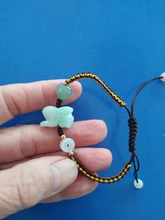 This Bracelet is made of 100%       Green Jade. Hand carved Jade       Rabbit. One side made of 10*10       mm Green Jade Heart. Another       side with 7*7 mm white Jade       Money bead.  The year of the Rabbit ( 2023.       2011. 1999. 1987.1975.1963.1951)  Rabbit luck color: Pink. Blue.       Red and Purple.  Luck Number is 3.4.9.  Hand made Brown and yellow.        colors string is a adjustable. Red Jade Bracelet Gift, Handmade Red Jade Bracelets, Year Of The Rabbit 2023, Hand-strung Jade Bracelet Jewelry, Rabbit 2023, Hand-strung Jade Beaded Bracelets, Jade Bracelet Chinese, Jade Rabbit, The Year Of The Rabbit