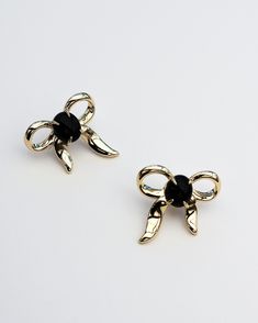 These Bow Statement Earrings will add a touch of sweet detailing to any outfit with our custom bow charm with natural cabochon onyx gemstones created in an over-sized design for elevated styling. Wear it with other styles from our core collection. DETAILS: High micron, ethically sourced 18K gold plating certified by LBMA Responsible Gold to meet international ethics standards. Natural onyx gemstones. Eco brass with 18K gold or 925 sterling silver plating. Nickel free 6 months warranty. Sold as a Black Bow Jewelry For Evening, Chic Yellow Gold Jewelry With Bow Detail, Chic Yellow Gold Jewelry With Bow, Black Jewelry With Decorative Bow For Party, Chic Clip-on Jewelry As Gift, Chic Clip-on Jewelry For Gift, Chic Clip-on Jewelry For Gifts, Yellow Gold Jewelry With Decorative Bow For Party, Chic Evening Jewelry With Black Enamel