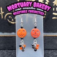 the earrings are decorated with pumpkins and black beads