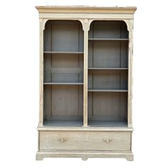 an old white bookcase with two doors and drawers on one side, against a white background