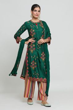 Bottle green kurta with multicolored thread embroidery. Piared with a striped palazzo. - Aza Fashions Green Unstitched Suit With Floral Embroidery In Traditional Drape, Green Embroidered Silk Unstitched Suit, Unstitched Green Suit With Floral Embroidery In Traditional Drape, Green Unstitched Suit With Floral Embroidery, Unstitched Green Suit With Floral Embroidery, Designer Green Embroidered Anarkali Set, Designer Embroidered Green Anarkali Set, Green Chanderi Palazzo Set With Floral Embroidery, Green Embroidered Anarkali Set For Eid