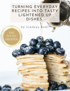 pancakes with blueberries and syrup being poured onto them by a teapot on top