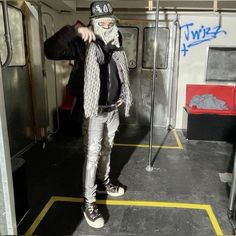 a man with a bandana on standing in a subway car