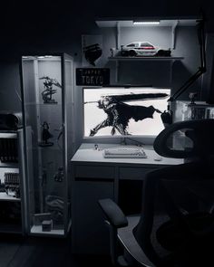 a room with a desk, chair and shelves filled with various items in it at night