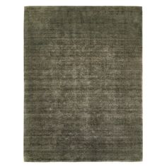 an area rug with dark green and light gray colors on the floor, it is very soft