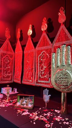 an assortment of decorative items on display in a room with red walls and flooring