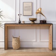 a wooden table with a basket on top and an old record player next to it