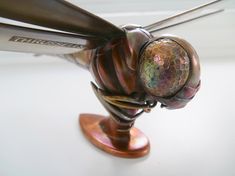 a close up view of a propeller on top of a white table with metal blades