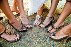 four people standing in a circle with their feet on the ground wearing high heeled sandals