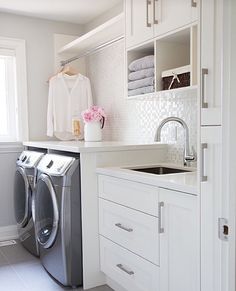 a washer and dryer in a white laundry room