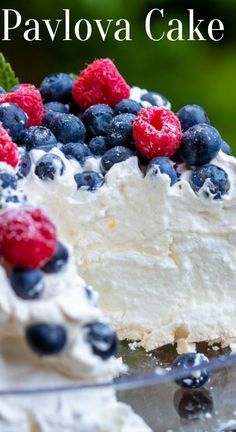 a close up of a cake with berries on it and the words pavlova cake