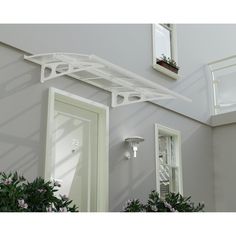 a house with two potted plants next to the door