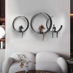 two circular metal hooks hang on the wall above a white couch