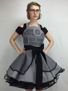 a woman wearing glasses and a dress with a star wars theme on it