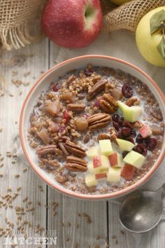 a bowl of oatmeal with apples and pecans