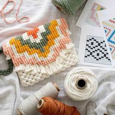 some yarn and scissors are laying on the table next to each other with different designs