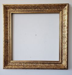 an old gold frame hanging on the wall