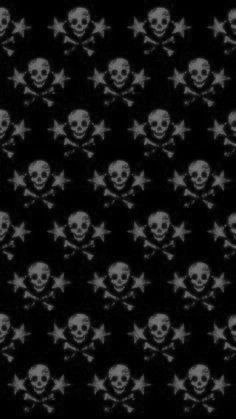 a black and white photo with skulls and crossbones in the middle on a dark background