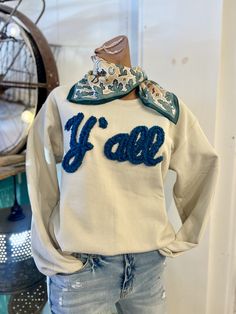 Get cozy in this Y'all cream sweatshirt with a teal puff graphic stitched on the front. Perfect for any western lover, this quirky and fun top adds a playful touch to any outfit. Yeehaw! 100% Cotton Cream Western Sweater, Womens Cozy Fall Outfits, Southern Chic Fashion, Western Embroidered Sweatshirt, Western Sweater Outfits, Cozy Mom Outfits, Iron On Patches Sweatshirt Ideas, Trending Embroidery, Concert Outfit Fall