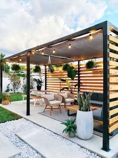 an outdoor living area with patio furniture and lighting