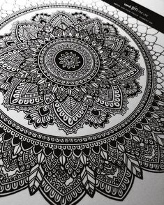 an intricate black and white drawing on paper