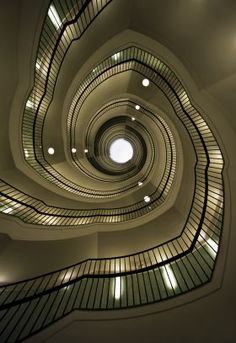 a spiral staircase in a building with lights on