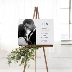 an easel with a wedding photo on it