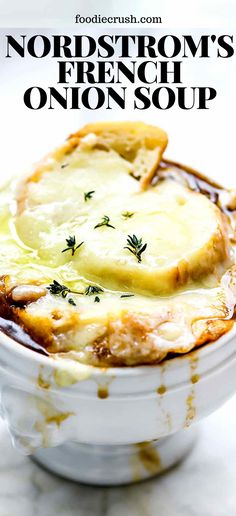 a close up of a bowl of food with bread and cheese in it on a table