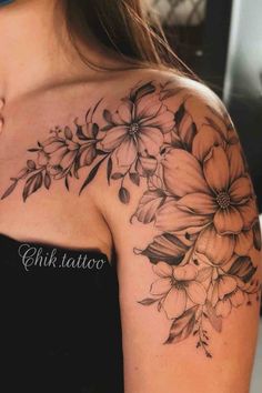 a woman's shoulder with flowers on it