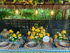 the table is set with blue and yellow flowers