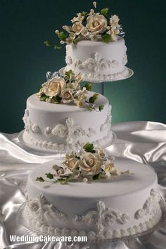 three tiered wedding cake with white flowers on top