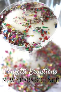 a glass filled with confetti and sprinkles on top of a table