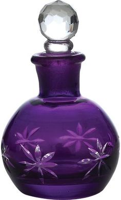 a purple glass bottle with flowers painted on the side and an acrylic stopper