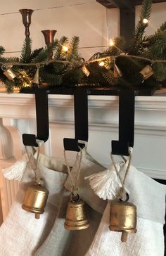 three bells are hanging from the mantle