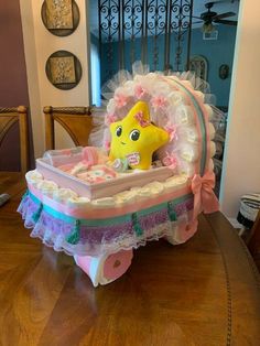 a baby's crib with a stuffed animal in it on a wooden table