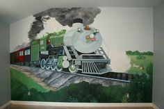 a train mural painted on the side of a wall next to a wooden floor in a room