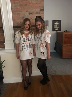 two girls dressed up in t - shirts with words on them