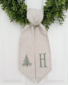 a door hanger with a monogrammed christmas tree on it