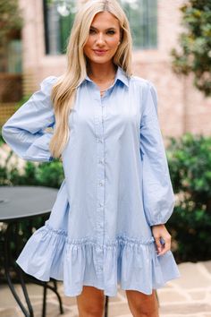 This dress is the definition of classic chic! The blue and white pinstripe are perfectly paired with the button up shirt dress cut. This dress is cut fairly generously so if you would like a bit more definition then you can easily add a belt. This dress is going to be an easy choice for work or dinner after! This dress features a collared neckline, button down front closure, long bubble sleeves, and a ruffled hemline.  Material has no amount of stretch.Model is wearing the small. Collared Striped Mini Dress For Spring, Spring Pinstripe Dresses For Workwear, Spring Pinstripe Dresses For Work, Elegant Striped Shirt Dress For Day Out, Spring Pinstripe Workwear Dresses, Chic Light Blue Shirt Dress For Day Out, Chic Striped Button-up Dresses, Chic Light Blue Button-up Dress, Button Up Shirt Dress