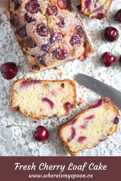 sliced cake with cherries and powdered sugar sitting on a doily next to a knife